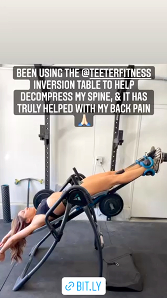 Teeter FitSpine Happy Back Club - person on inversion table in gym