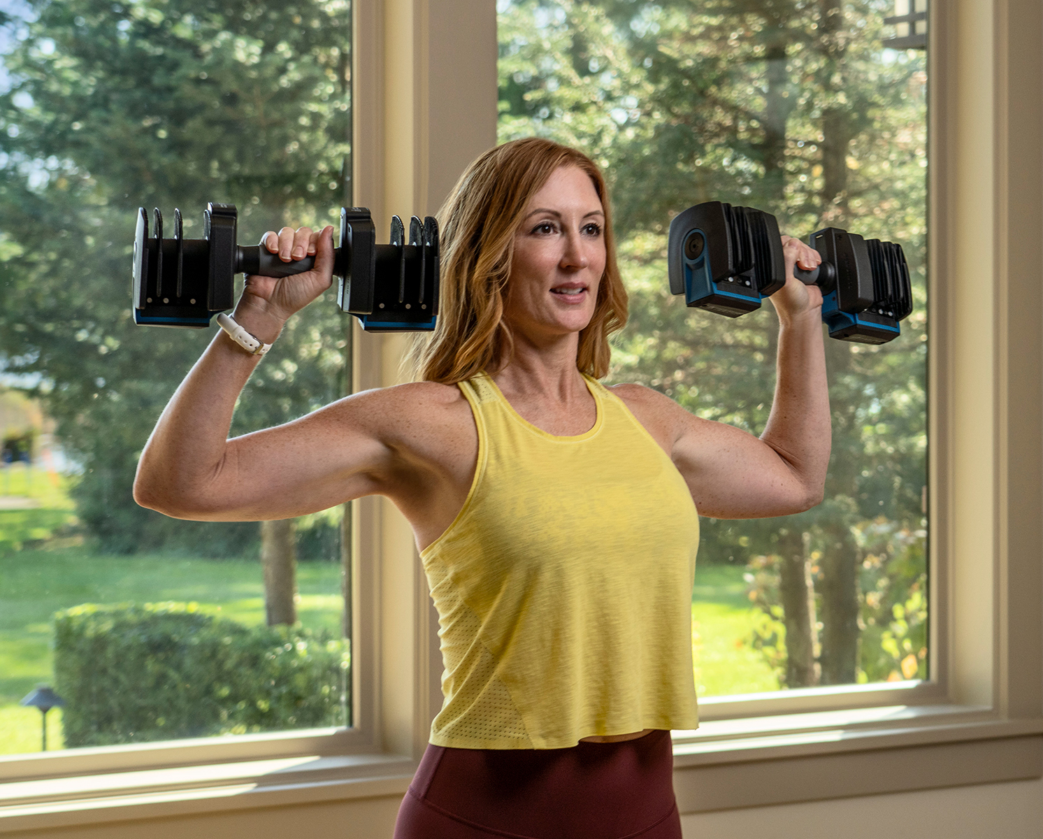 Woman Using ProFlex Dumbbells for a Shoulder Press Workout